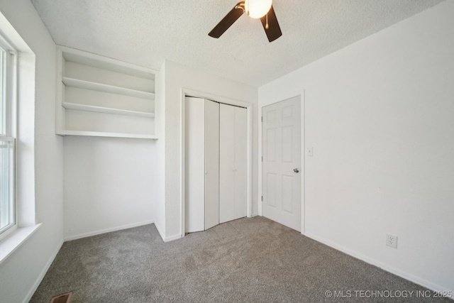 10785 E Dogwood Ct, Claremore, OK 74019 - unfurnished bedroom featuring a closet, baseboards, a textured ceiling, a ceiling fan, and carpet