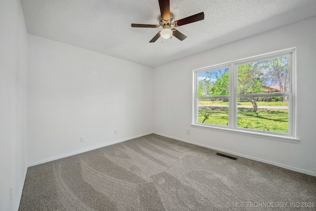 10785 E Dogwood Ct, Claremore, OK 74019 - carpeted spare room with baseboards, visible vents, a textured ceiling, and a ceiling fan