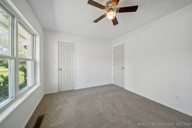 10785 E Dogwood Ct, Claremore, OK 74019 - carpeted spare room with visible vents, ceiling fan, baseboards, and a textured ceiling