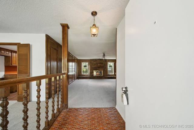 10785 E Dogwood Ct, Claremore, OK 74019 - hall featuring a textured ceiling and dark colored carpet