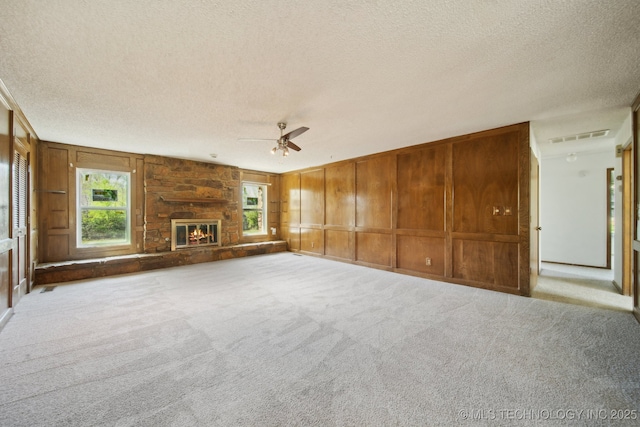 10785 E Dogwood Ct, Claremore, OK 74019 - unfurnished living room featuring carpet flooring, visible vents, a textured ceiling, and a ceiling fan
