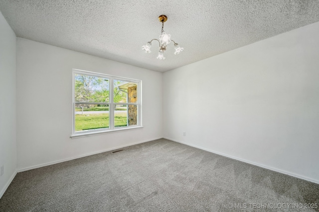 10785 E Dogwood Ct, Claremore, OK 74019 - carpeted empty room featuring a notable chandelier, a textured ceiling, and baseboards