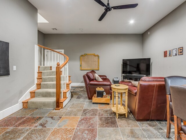 263 Eagles Nest Path, Stigler, OK 74462 - living area featuring stairway, baseboards, a ceiling fan, and stone tile floors