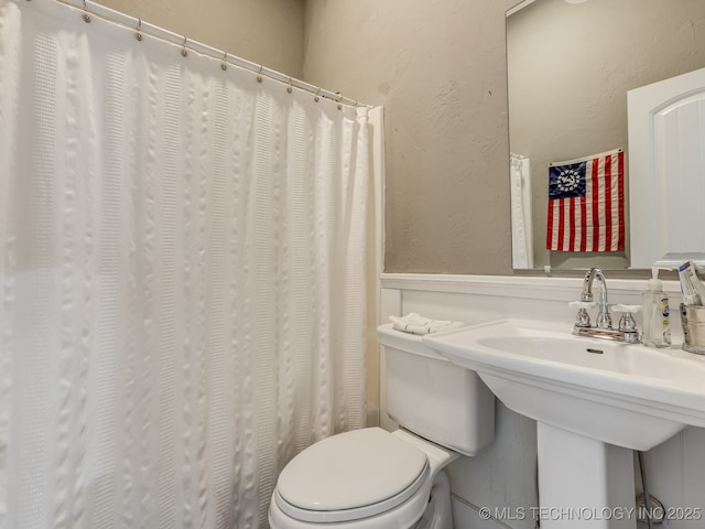 263 Eagles Nest Path, Stigler, OK 74462 - bathroom with a wainscoted wall, a decorative wall, and toilet