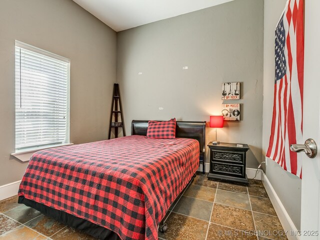 263 Eagles Nest Path, Stigler, OK 74462 - bedroom with baseboards and stone tile floors