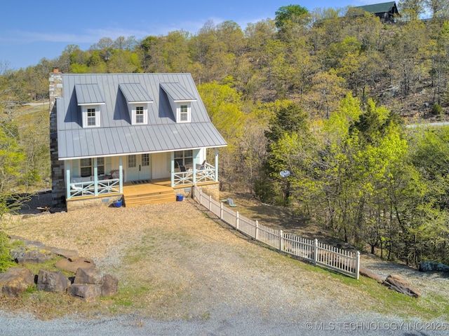 263 Eagles Nest Path, Stigler, OK 74462 - view of front of house featuring fence, a standing seam roof, covered porch, a view of trees, and metal roof