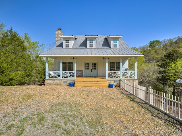 263 Eagles Nest Path, Stigler, OK 74462 - back of house featuring a chimney, fence, board and batten siding, and metal roof