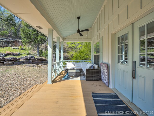 263 Eagles Nest Path, Stigler, OK 74462 - wooden terrace with outdoor lounge area, visible vents, and ceiling fan