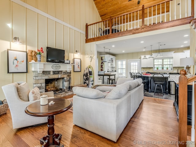 263 Eagles Nest Path, Stigler, OK 74462 - living area with a fireplace, light wood-style flooring, and a towering ceiling