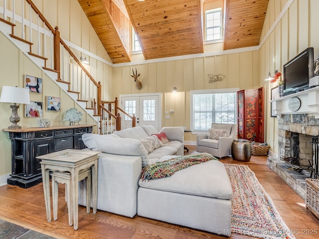 263 Eagles Nest Path, Stigler, OK 74462 - living room with light wood-style floors, stairway, wooden ceiling, a stone fireplace, and high vaulted ceiling