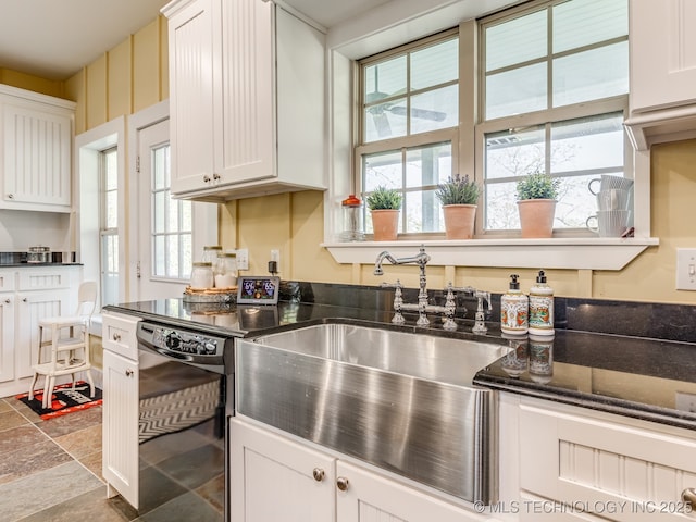 263 Eagles Nest Path, Stigler, OK 74462 - kitchen featuring dark stone countertops, a sink, stone finish flooring, white cabinetry, and black dishwasher