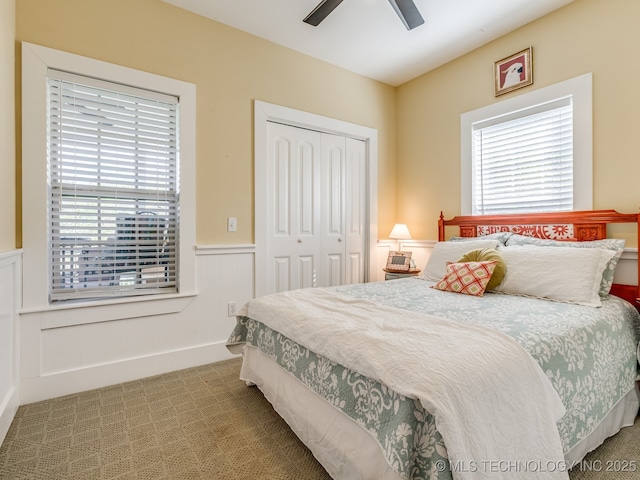 263 Eagles Nest Path, Stigler, OK 74462 - carpeted bedroom with a wainscoted wall, a closet, and ceiling fan