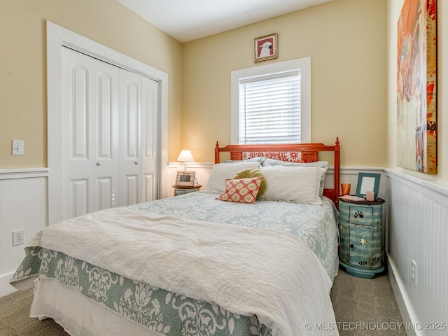263 Eagles Nest Path, Stigler, OK 74462 - carpeted bedroom featuring wainscoting, a closet, and a decorative wall