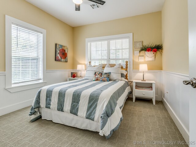 263 Eagles Nest Path, Stigler, OK 74462 - carpeted bedroom featuring visible vents, a wainscoted wall, and multiple windows