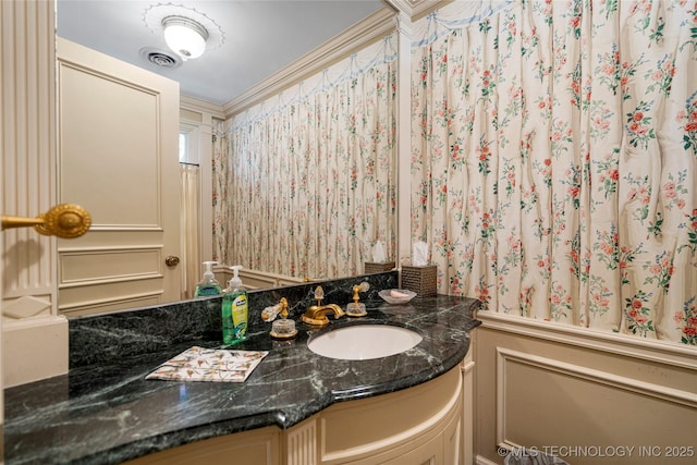 bathroom with wallpapered walls, visible vents, and vanity