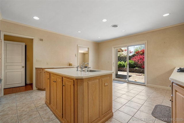 kitchen featuring ornamental molding, a sink, and light tile patterned flooring