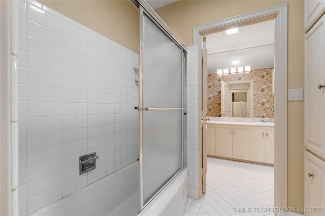 full bathroom with tile patterned floors, vanity, and shower / bath combination with glass door