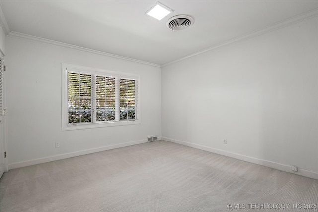 spare room with light carpet, baseboards, visible vents, and ornamental molding