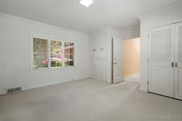 unfurnished bedroom with light carpet, ornamental molding, visible vents, and baseboards