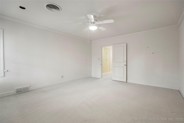 empty room featuring crown molding, visible vents, a ceiling fan, and light colored carpet