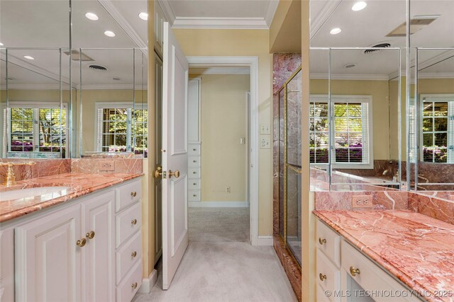 bathroom with baseboards, recessed lighting, a shower stall, vanity, and ornamental molding