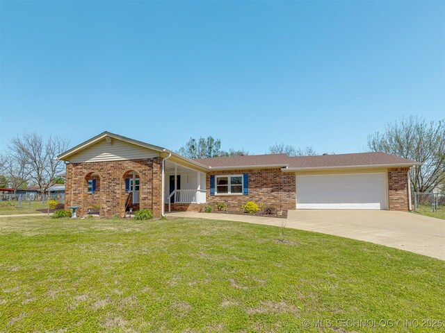 721 Ladd Ave W, Depew, OK 74028 - ranch-style house with brick siding, a garage, concrete driveway, and covered porch
