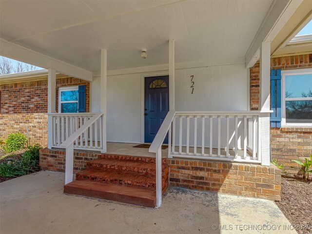 721 Ladd Ave W, Depew, OK 74028 - property entrance featuring brick siding and covered porch