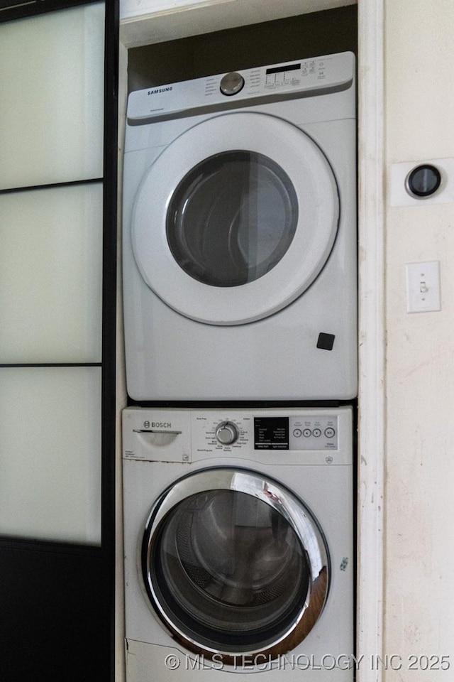 washroom with laundry area and stacked washer / drying machine