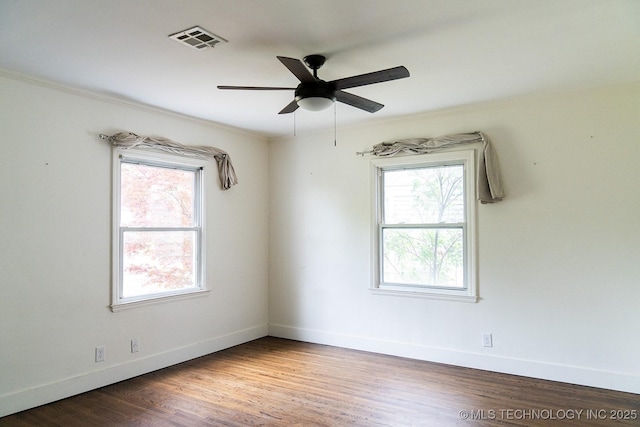 unfurnished room with baseboards, visible vents, and a wealth of natural light