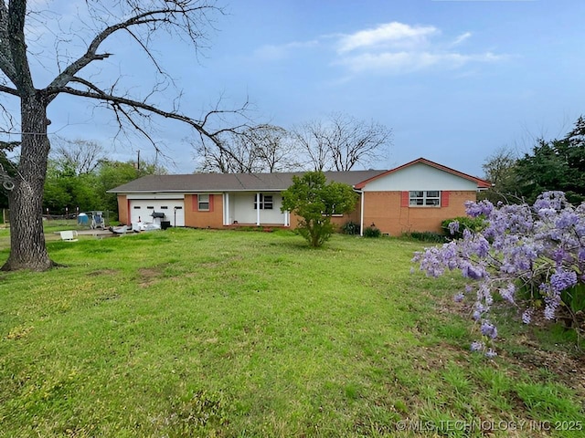 rear view of property featuring a yard and a garage