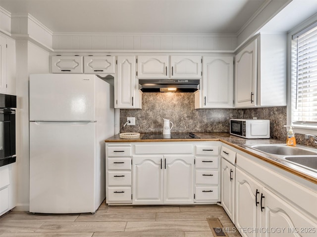 kitchen with tasteful backsplash, light wood-type flooring, under cabinet range hood, white cabinetry, and black appliances