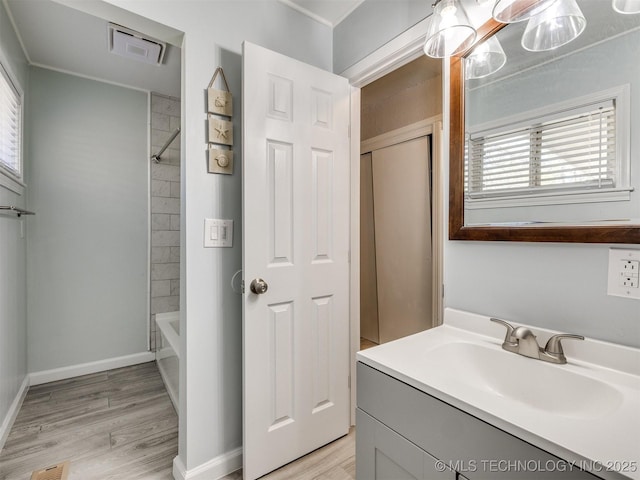 full bathroom with visible vents, wood finished floors, vanity, and plenty of natural light