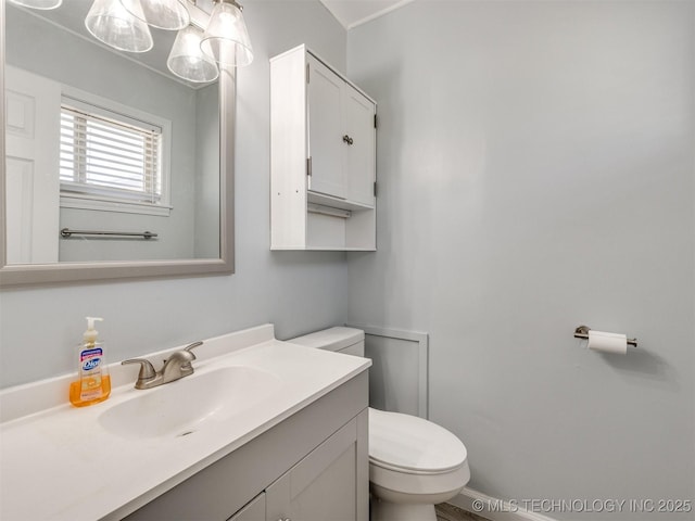 half bathroom with toilet and vanity
