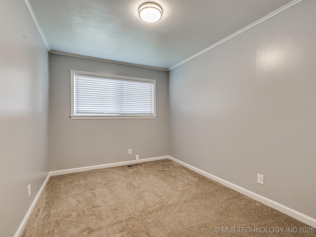 unfurnished room featuring carpet flooring, baseboards, and crown molding