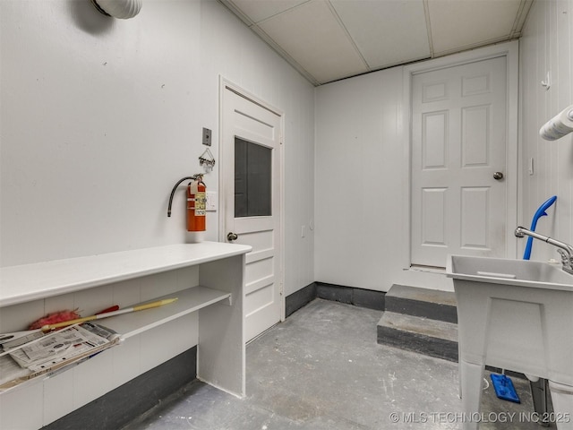 interior space with unfinished concrete flooring and a sink