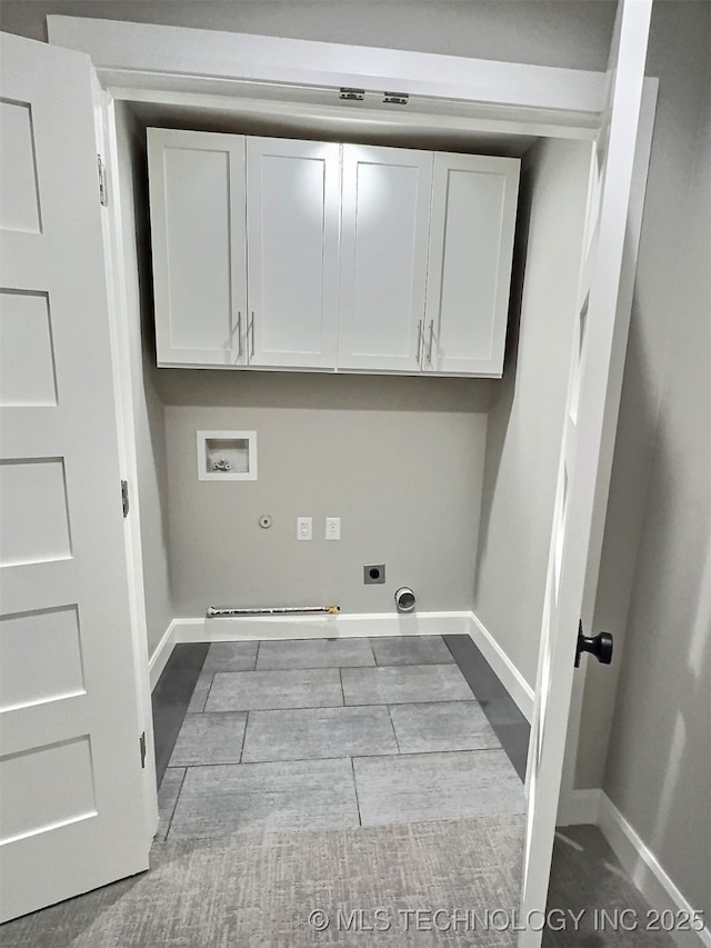 washroom with hookup for an electric dryer, washer hookup, hookup for a gas dryer, baseboards, and cabinet space