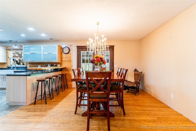 dining space featuring recessed lighting, a notable chandelier, and light wood-type flooring