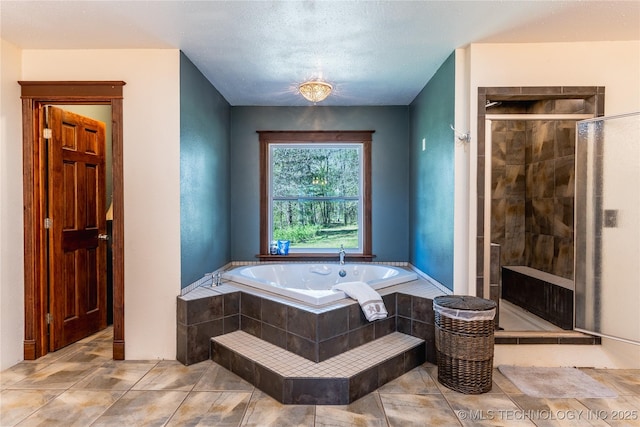 full bath with a bath and a shower stall