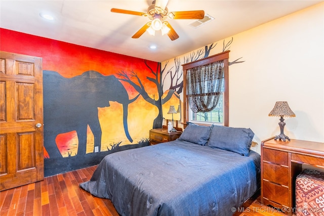 bedroom featuring recessed lighting, an accent wall, visible vents, and wood finished floors