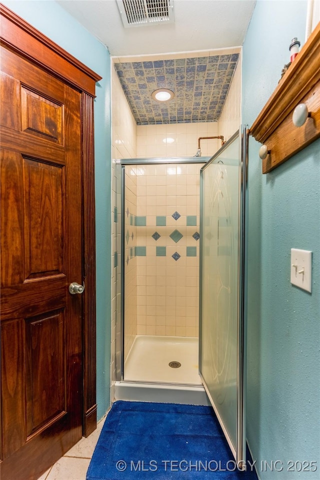 full bath featuring visible vents, a shower stall, and tile patterned flooring