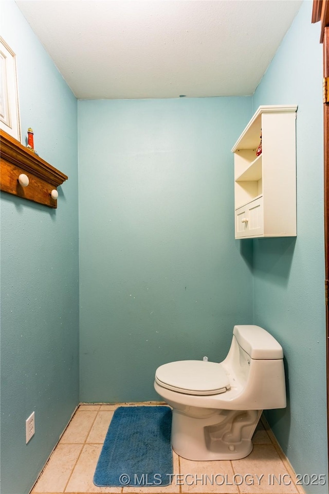 bathroom featuring toilet and tile patterned flooring