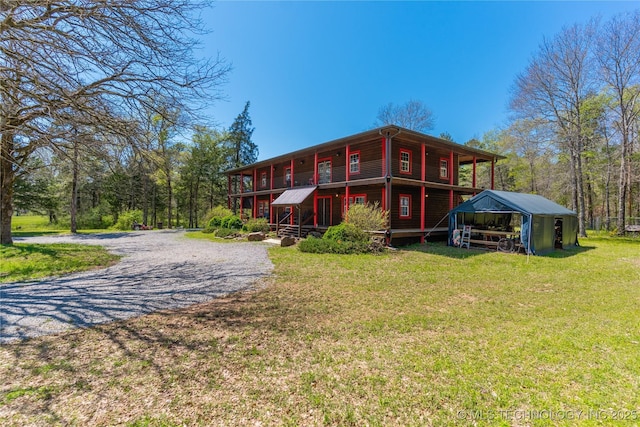 rear view of property featuring a yard