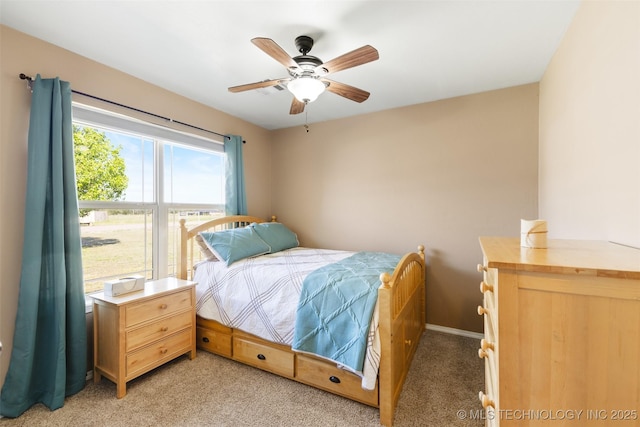 bedroom with light colored carpet, baseboards, and a ceiling fan