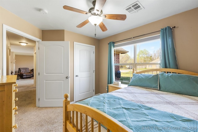 carpeted bedroom featuring visible vents and ceiling fan