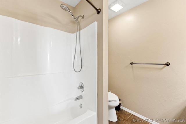 full bath featuring tile patterned flooring, bathtub / shower combination, baseboards, and toilet
