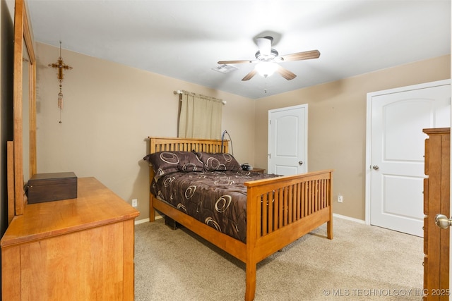 carpeted bedroom featuring visible vents, baseboards, and ceiling fan