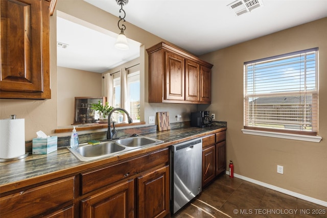 kitchen featuring dark tile patterned floors, baseboards, visible vents, dishwasher, and a sink
