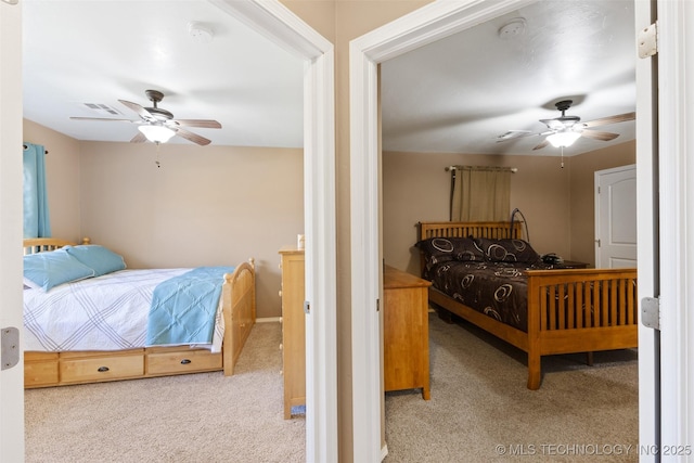 carpeted bedroom featuring visible vents and a ceiling fan