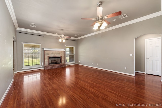 705 SW 20th St, Wagoner, OK 74467 - unfurnished living room featuring baseboards, a ceiling fan, visible vents, arched walkways, and wood finished floors