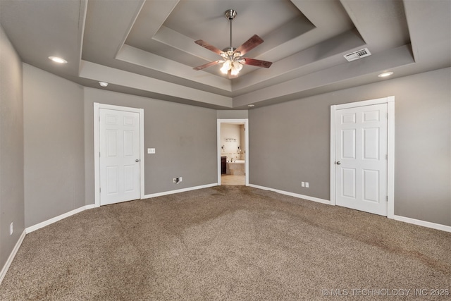 705 SW 20th St, Wagoner, OK 74467 - unfurnished bedroom featuring a tray ceiling, carpet flooring, and baseboards